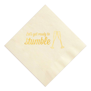 Raise a toast with the Toast & Stumble Napkin, a symbol of spirited celebration. It boldly declares “Let’s get ready to Stumble” alongside a graphic of clinking champagne flutes, perfectly capturing the essence of a lively, festive occasion filled with toasts, cheer, and unforgettable moments.