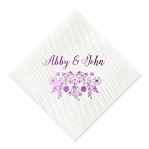 The Garden Flourish Napkin design exudes old-world romance. The couple's names are elegantly scripted in a swirling, romantic font. Below, a whimsical cascade of florals and greenery, dotted with hidden hearts and interspersed flowers, evokes the charm of a bride's cascading bouquet.