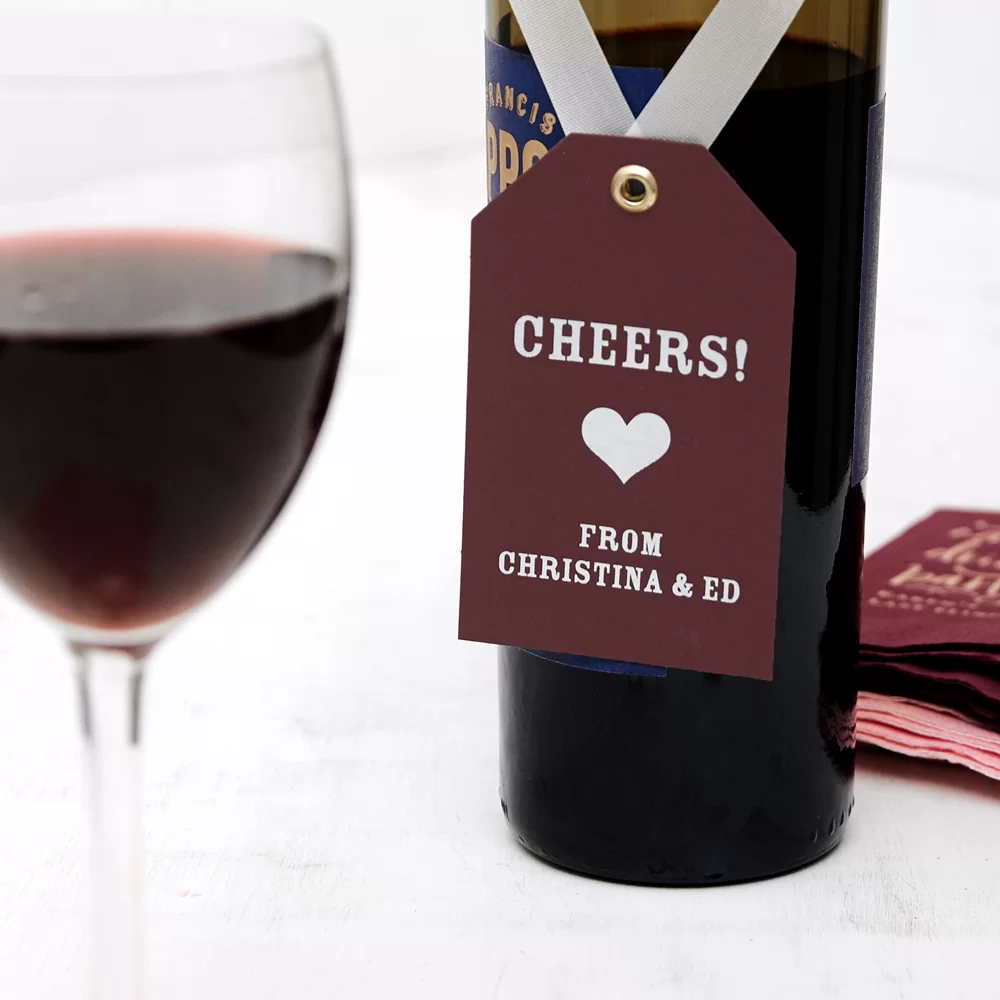 gift tag on a ribbon hanging on a wine bottle