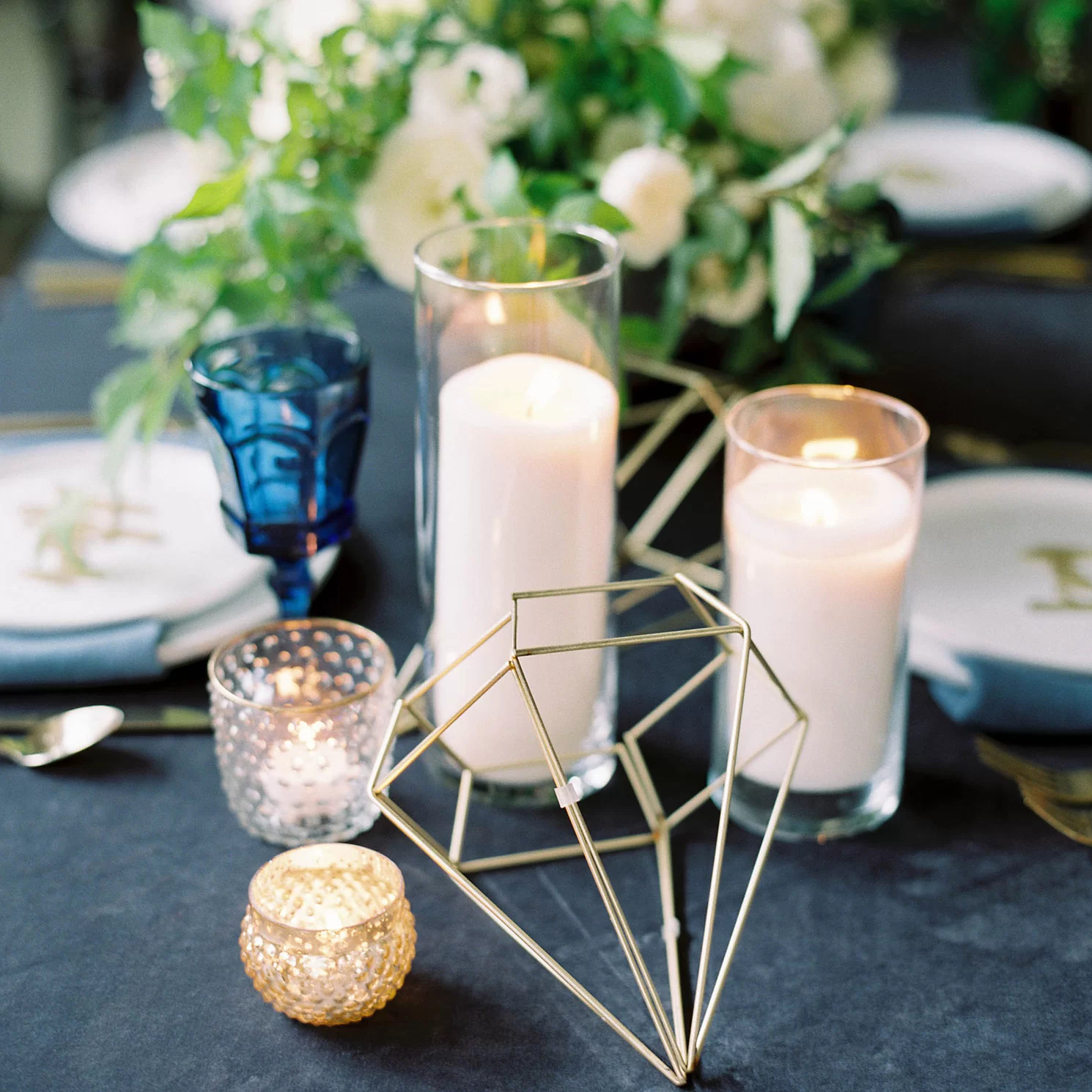 industrial glam party table decorations with wire diamonds, colored glasses and garland