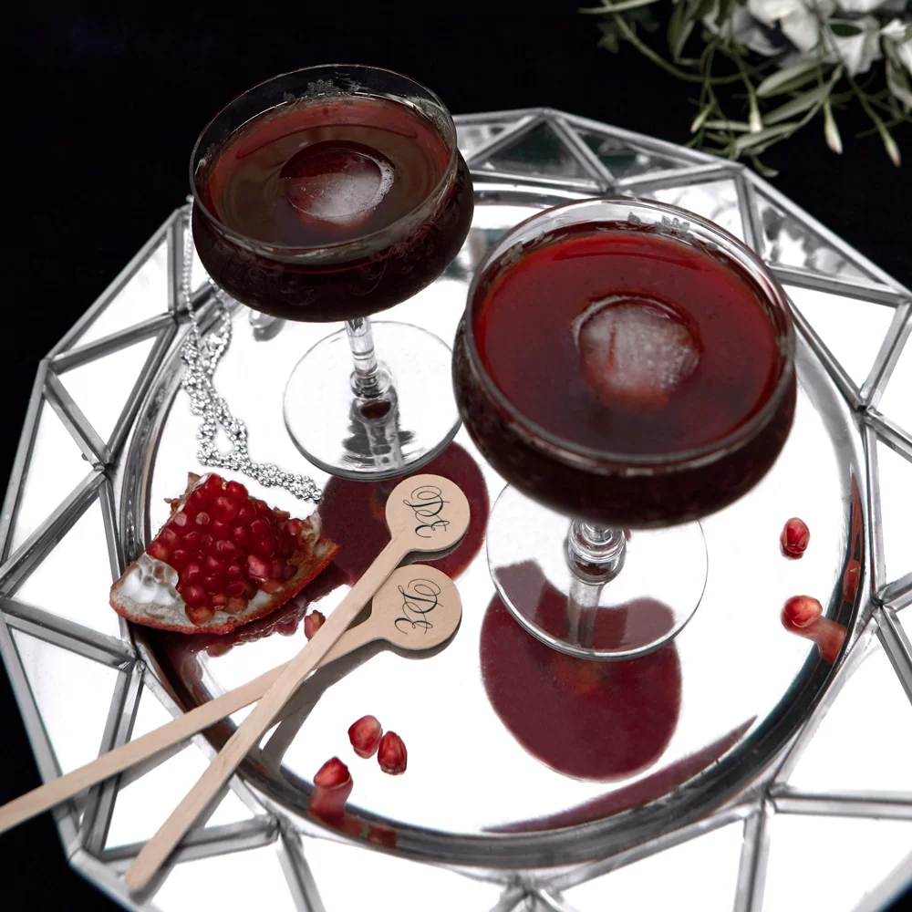 bourbon pomegranate manhattan cocktail recipe with custom drink stirrers