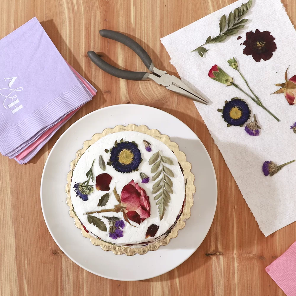 floral cake viewed from above with pliers and napkins