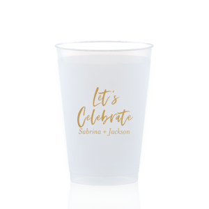 Toast to joyous occasions with the Festive Let's Celebrate Frosted Cup. Emblazoned with "Let’s Celebrate" in an exuberant script font, it embodies the spirit of festivity. Beneath, the couple’s first names invite guests to partake in the joy, making it both a welcoming gesture and a celebration of the couple.