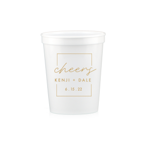 The Framed Cheers Cup design elegantly frames the word "cheers" in a handwritten-style script, creating a subtle yet sophisticated toast to the couple. Positioned below are their names and the event date, all encased within a tasteful artful border, adding a refined touch to this celebratory cup.