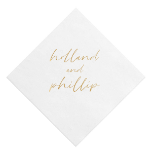 The Golden Names Napkin features elegant handwritten-style lettering of the couple's names with a clean, minimalist layout for a timeless look. Add it to your celebration to create a refined tablescape that feels thoughtful and cohesive. Lovely for wedding receptions or engagement parties!