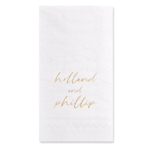 The Golden Names Napkin features elegant handwritten-style lettering of the couple's names with a clean, minimalist layout for a timeless look. Add it to your celebration to create a refined tablescape that feels thoughtful and cohesive. Lovely for wedding receptions or engagement parties!