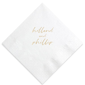 The Golden Names Napkin features elegant handwritten-style lettering of the couple's names with a clean, minimalist layout for a timeless look. Add it to your celebration to create a refined tablescape that feels thoughtful and cohesive. Lovely for wedding receptions or engagement parties!