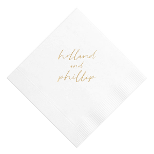 The Golden Names Napkin features elegant handwritten-style lettering of the couple's names with a clean, minimalist layout for a timeless look. Add it to your celebration to create a refined tablescape that feels thoughtful and cohesive. Lovely for wedding receptions or engagement parties!