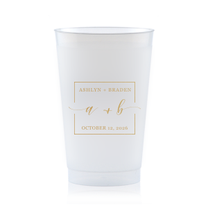 The Square Monogram Frame Cup features elegant script of the couple’s initials, paired with their names and special date within a clean rectangular border for a refined drinkware detail. Use it to elevate beverage service with a polished, personalized touch. Refined for wedding receptions or rehearsal dinners.
