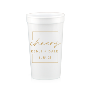 The Framed Cheers Cup design elegantly frames the word "cheers" in a handwritten-style script, creating a subtle yet sophisticated toast to the couple. Positioned below are their names and the event date, all encased within a tasteful artful border, adding a refined touch to this celebratory cup.