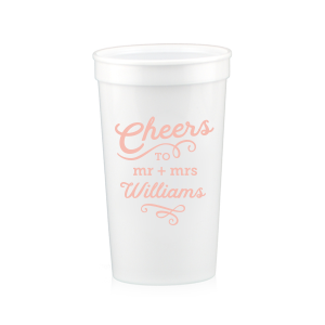 The Swirling Cheers Cup exudes exuberance. The design features "Cheers" fancifully scripted, underscored by a flourish. Below, the couple's titles "Mr. and Mrs." lead into their last name, further accentuated by an ornate flourish. These swirling designs add a sense of fanciful charm, making the cup a perfect vessel for toasting. 
