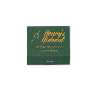 This Martini Pick Where It's Always Happy Hour Matchbox features bold script reading “Henry’s Hideout,” a martini olive pick icon, and the phrase “Where It’s Always Happy Hour” in warm golden lettering. Create a fun, personalized bar vibe guests will love. Perfect for weddings, birthdays, or bachelor parties.