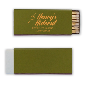 This Martini Pick Where It's Always Happy Hour Matchbox features bold script reading “Henry’s Hideout,” a martini olive pick icon, and the phrase “Where It’s Always Happy Hour” in warm golden lettering. Create a fun, personalized bar vibe guests will love. Perfect for weddings, birthdays, or bachelor parties.