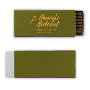 This Martini Pick Where It's Always Happy Hour Matchbox features bold script reading “Henry’s Hideout,” a martini olive pick icon, and the phrase “Where It’s Always Happy Hour” in warm golden lettering. Create a fun, personalized bar vibe guests will love. Perfect for weddings, birthdays, or bachelor parties.