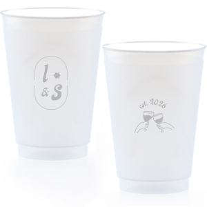 The Sunburst Initial & Toasting Glass Cup features an oval frame with classic initials, a subtle star accent, and a toast illustration with the date on the reverse. Order yours to serve drinks with a chic, custom feel guests will love. Fitting for weddings and engagement parties!