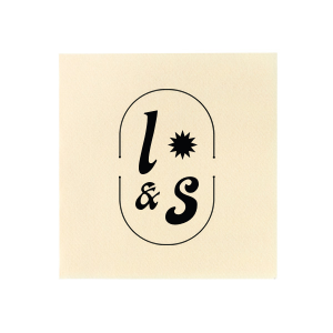 The Sunburst Initial Napkin features bold initials framed by a modern oval emblem with a sunburst accent. Add it to your powder room or dining table to create a polished, custom look guests will notice. Perfect for weddings, housewarmings, or elevated entertaining!