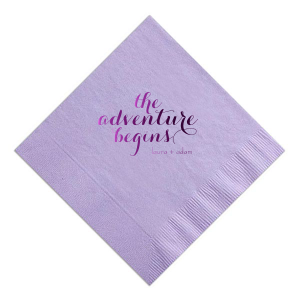 The Elegant Swirl Script Adventure Begins Napkin captures the essence of a new journey with "The Adventure Begins" in an energetic swirling script. This straightforward design, focusing on the excitement of the couple's upcoming life together, makes a striking statement.