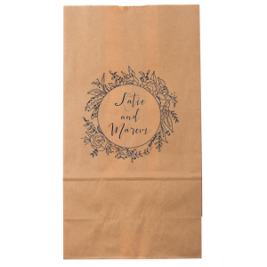 The Regal Wreath Bag design presents an elegant and abundant floral wreath, symbolizing luxury and nature's richness. Enclosed within this lush botanical embrace, the couple's names are elegantly scripted, adding a touch of royal sophistication. This design artfully marries opulence with the charm of natural abundance.