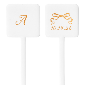 The Bow-Tied Date Stir Stick features a graceful bow graphic atop one side, with the flip side showcasing your initial in an ornate, yet understated script. This elegant stirrer adds a touch of charm to any celebration, making it an ideal keepsake for guests to remember your occasion by. Perfect for adding a touch of sophistication to weddings, anniversaries, or elegant soirees.