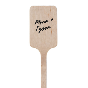 The Lovers' Script Stir Stick offers a touch of whimsy and romance, allowing you to personalize it with your names in a font that is dreamy and full of charm, with sweeping curves and elegant flourishes that capture the feeling of a love story. This personalized stir stick is a beautiful addition to any couple's event, providing a fanciful and intimate detail to your signature beverages.