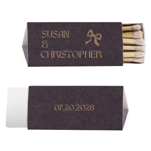 Ignite a lifetime of memories with the Modern Names and Date Bow Matchbox, personalized with the couple's names and the date of your event, complemented by a hand-drawn bow graphic. A charming keepsake for weddings, engagement parties, or anniversaries.