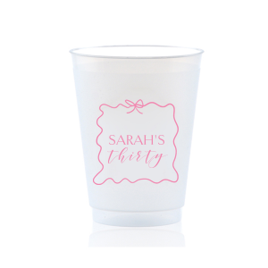 Sip in style at your birthday bash with the Ribbon Frame Birthday Bash Cup, elegantly framed like a ribbon and bow, featuring your name and new age in a whimsical script. A festive and personalized touch to celebrate another fabulous year.