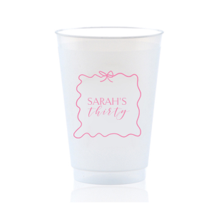 Sip in style at your birthday bash with the Ribbon Frame Birthday Bash Cup, elegantly framed like a ribbon and bow, featuring your name and new age in a whimsical script. A festive and personalized touch to celebrate another fabulous year.