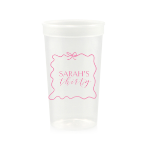 Sip in style at your birthday bash with the Ribbon Frame Birthday Bash Cup, elegantly framed like a ribbon and bow, featuring your name and new age in a whimsical script. A festive and personalized touch to celebrate another fabulous year.