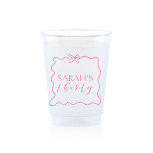 Sip in style at your birthday bash with the Ribbon Frame Birthday Bash Cup, elegantly framed like a ribbon and bow, featuring your name and new age in a whimsical script. A festive and personalized touch to celebrate another fabulous year.