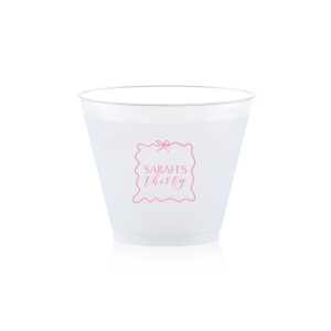 Sip in style at your birthday bash with the Ribbon Frame Birthday Bash Cup, elegantly framed like a ribbon and bow, featuring your name and new age in a whimsical script. A festive and personalized touch to celebrate another fabulous year.