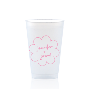 Sip in style at your whimsical wedding with the Kitschy Cocktail Hour Floral Frame Cup. Personalize this charming vessel with the couple's names, elegantly scripted within a blooming flower-shaped frame. A modern and enchanting choice for your celebratory toasts.