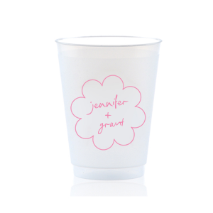 Sip in style at your whimsical wedding with the Kitschy Cocktail Hour Floral Frame Cup. Personalize this charming vessel with the couple's names, elegantly scripted within a blooming flower-shaped frame. A modern and enchanting choice for your celebratory toasts.