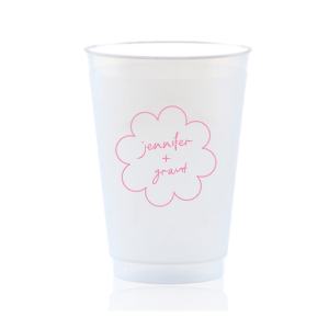 Sip in style at your whimsical wedding with the Kitschy Cocktail Hour Floral Frame Cup. Personalize this charming vessel with the couple's names, elegantly scripted within a blooming flower-shaped frame. A modern and enchanting choice for your celebratory toasts.