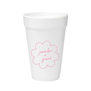 Sip in style at your whimsical wedding with the Kitschy Cocktail Hour Floral Frame Cup. Personalize this charming vessel with the couple's names, elegantly scripted within a blooming flower-shaped frame. A modern and enchanting choice for your celebratory toasts.