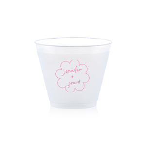 Sip in style at your whimsical wedding with the Kitschy Cocktail Hour Floral Frame Cup. Personalize this charming vessel with the couple's names, elegantly scripted within a blooming flower-shaped frame. A modern and enchanting choice for your celebratory toasts.