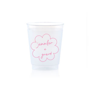 Sip in style at your whimsical wedding with the Kitschy Cocktail Hour Floral Frame Cup. Personalize this charming vessel with the couple's names, elegantly scripted within a blooming flower-shaped frame. A modern and enchanting choice for your celebratory toasts.