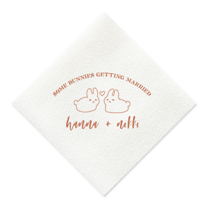 Hop into matrimonial joy with the Some Bunnies Wedding Napkin, complete with an adorable drawing of two bunnies and a heart nestled between them. The playful phrase "Some Bunnies Getting Married" sets a whimsical tone, while the area below awaits the couple's names, scripted with modern elegance. A delightful addition to your wedding tablescapes.