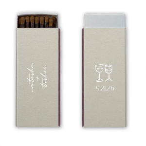 Light up your autumnal love story with the Boho Terracotta Line Art Wedding Matchbox. Customize one side with the couple's names elegantly scripted, symbolizing unity. The other side is adorned with a minimalist line drawing of two clinking wine glasses, topped by the wedding date in a refined serif font, ready to commemorate your chic, moody celebration.