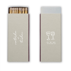 Light up your autumnal love story with the Boho Terracotta Line Art Wedding Matchbox. Customize one side with the couple's names elegantly scripted, symbolizing unity. The other side is adorned with a minimalist line drawing of two clinking wine glasses, topped by the wedding date in a refined serif font, ready to commemorate your chic, moody celebration.