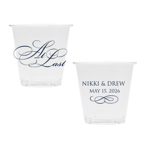 The At Last Cup features elegant calligraphy reading “At Last” reversed with the couple's names and a graceful flourish for a timeless drinkware detail. Use it to elevate your celebration with a romantic touch. Refined for wedding receptions and sentimental keepsakes.
