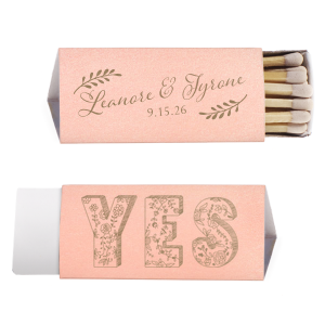 Ignite love’s spark with the Romantic YES Wedding Matchbox. Elegant leafy boughs frame the newlyweds' names in flourishing script on one side. Flip to an exuberant, floral-filled "YES" on the other—a timeless, botanical cheer for your happily ever after!
