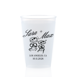 The Wedding Glass & Bow Cup is the must have trendy design for your one of a kind lifetime event. Featuring hand-drawn bows tied around champagne glasses alongside customizable text in the screen printed ink color of your choice to best pair with your party's vibe.