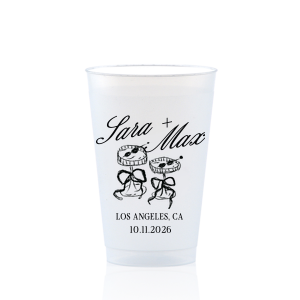 The Wedding Glass & Bow Cup is the must have trendy design for your one of a kind lifetime event. Featuring hand-drawn bows tied around champagne glasses alongside customizable text in the screen printed ink color of your choice to best pair with your party's vibe.