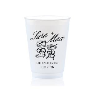 The Wedding Glass & Bow Cup is the must have trendy design for your one of a kind lifetime event. Featuring hand-drawn bows tied around champagne glasses alongside customizable text in the screen printed ink color of your choice to best pair with your party's vibe.