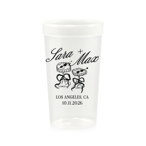 The Wedding Glass & Bow Cup is the must have trendy design for your one of a kind lifetime event. Featuring hand-drawn bows tied around champagne glasses alongside customizable text in the screen printed ink color of your choice to best pair with your party's vibe.