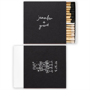  Light up the night with the Kitschy Cocktail Hour Toasting Glasses Matches, a whimsically modern addition to your wedding day. Each matchbox, personalized with the couple's names in a hand-drawn-inspired script, flips to reveal a contemporary line drawing of a wine glass pyramid and the date, perfect for commemorating your toast to forever.