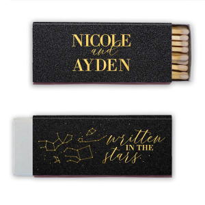 The Written in the Stars Matchbox dazzles with celestial charm. One side features "written in the stars" in twinkling script amidst a constellation graphic, capturing a heavenly feel. The other side proudly displays the event stars' names in bold all-caps, anchoring the cosmic theme.
