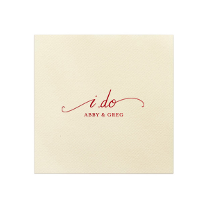 The I Do Flourish Name Napkin design artistically transforms the iconic wedding vow into a visual centerpiece. Flourished script forms an umbrella-like frame around "I Do," highlighting the couple's names, which are in a contrasting all-caps block font. This napkin combines elegance with artistic expression in a memorable keepsake.