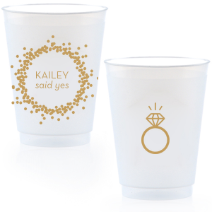 Cheers to the newly betrothed with the Engagement Ring Cup, bursting with celebratory bubbles and a bright 'said yes.' Flip to reveal a sparkling solitaire ring, toasting to the promise of a dazzling future together.