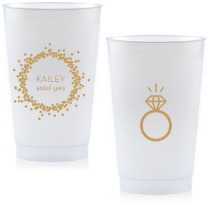 Cheers to the newly betrothed with the Engagement Ring Cup, bursting with celebratory bubbles and a bright 'said yes.' Flip to reveal a sparkling solitaire ring, toasting to the promise of a dazzling future together.